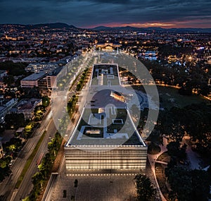 Budapest, Hungary - Aerial view of the iIlluminated Museum of Ethnography at City Park with Heroes` Square and skyline of Budapest