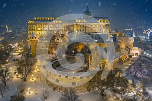 Budapest, Hungary - Aerial view of illuminated Buda Castle Royal Palace on a snowy evening