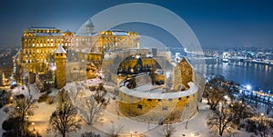 Budapest, Hungary - Aerial view of illuminated Buda Castle Royal Palace on a winter night with snowy park