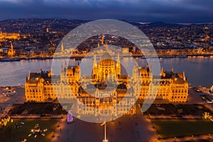 Budapest, Hungary - Aerial view of the illuminated Hungarian Parliament building at golden hour with Christmas tree