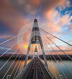 Budapest, Hungary - Aerial view of Megyeri Bridge over River Danube with beautiful golden sky and clouds