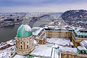 Budapest, Hungary - Aerial view of the snowy Buda Castle Royal Palace with Statue of Liberty, Elisabeth and Liberty Bridge