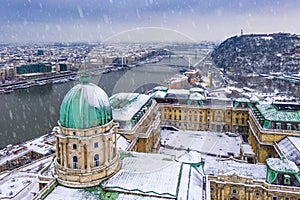 Budapest, Hungary - Aerial view of the snowy Buda Castle Royal Palace with Statue of Liberty, Elisabeth and Liberty Bridge