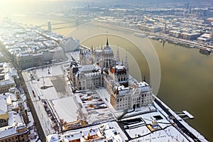 Budapest, Hungary - Aerial view of the snowy Parliament of Hungary by River Danube on a foggy winter morning