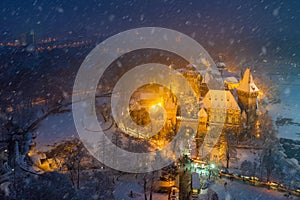 Budapest, Hungary - Aerial view of snowy Vajdahunyad castle in City Park with lovely Christmas market