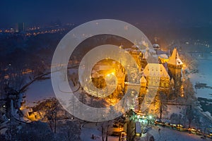 Budapest, Hungary - Aerial view of snowy Vajdahunyad castle in City Park with lovely Christmas market