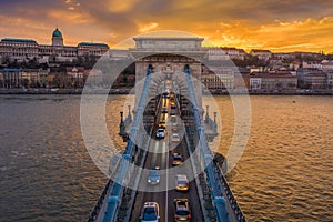 Budapest, Hungary - Aerial view of Szechenyi Chain Bridge with afternoon traffic, beautiful golden sunset sky