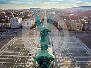 Budapest, Hungary - Angel sculpture from behind on the top of Heroes` Square at sunset