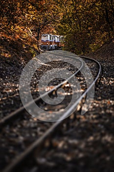 Budapest, Hungary - Beautiful autumn scenery with the Children`s train on the S curve track in the Hungarian woods of Huvosvolgy