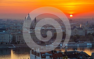 Budapest, Hungary - Beautiful golden sunrise over Budapest with St. Stephen`s Basilca, cruise ship on River Danube