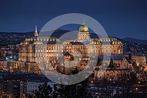 Budapest, Hungary - The beautiful illuminated Buda Castle Royal Palace as seen from Gellert Hill in winter time