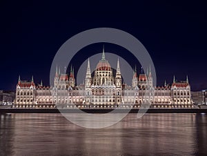 Budapest, Hungary - The beautiful illuminated Hungarian Parliament building Orszaghaz by night with dark blue sky photo