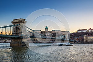 Budapest, Hungary - Beautiful Szechenyi Chain Bridge with sightseeing boat on River Danube