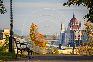 Budapest, Hungary - Bench and autumn foliage on the Buda hill with the Hungarian Parliament