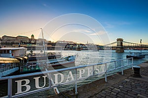 Budapest, Hungary - Boats on River Danube with Buda Castle Royal Palace and Szechenyi Chain Bridge