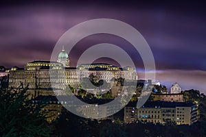 Budapest, Hungary - Buda Castle Royal Palace at night with smoke at background after the fireworks of State Foundation Day