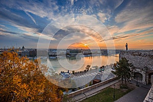 Budapest, Hungary - Colorful autumn trees at Buda Castle with skyline view of Budapest at sunrise