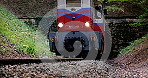 BUDAPEST, HUNGARY - FEB.19.2020: A diesel train chugs through a tunnel in a mountainside