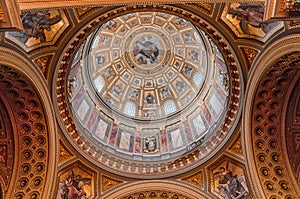 Budapest, Hungary - Feb 8, 2020: Upward view of gilded golden dome cupola inside St. Stephen`s Basilica
