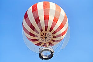 Budapest, Hungary - February 10, 2023: View of a red and white hot air balloon on a blue sky background