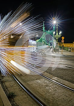 Budapest, Hungary - Festively decorated light tram Fenyvillamos on the move at Liberty Bridge Szabadsag hid by night