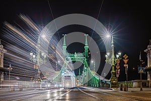 Budapest, Hungary - Festively decorated light tram Fenyvillamos on the move at Liberty Bridge Szabadsag hid by night