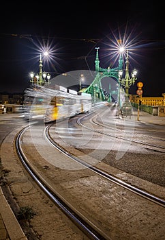 Budapest, Hungary - Festively decorated light tram Fenyvillamos on the move at Liberty Bridge Szabadsag hid by night