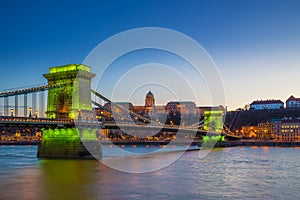 Budapest, Hungary - Green light illuminated Szechenyi Chain Bridge over River Danube and Buda Castle Royal Palace