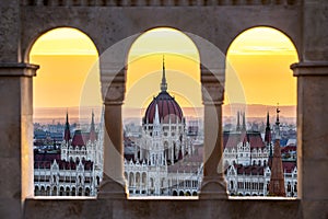 Budapest, Hungary - The Hungarian Parliament building at sunrise looking through old stone windows