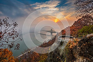Budapest, Hungary - Lookout on Gellert Hill with Liberty Bridge Szabadsag Hid, fog over River Danube, colorful sky and clouds