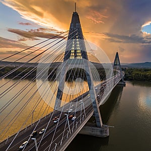 Budapest, Hungary - Megyeri Bridge over River Danube at sunset with heavy traffic, beautiful dramatic clouds