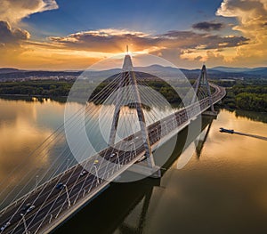Budapest, Hungary - Megyeri Bridge at sunset with speedboat on River Danube and heavy traffic