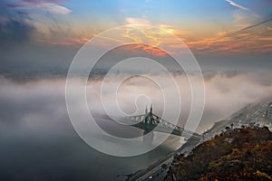 Budapest, Hungary - Mysterious foggy sunrise with Liberty Bridge Szabadsag hid and hazy skyline of Budapest