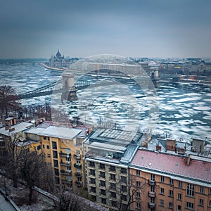Budapest, Hungary - Panoramic skyline view of the Szechenyi Chain Bridge on the icy River Danube with Parliament and