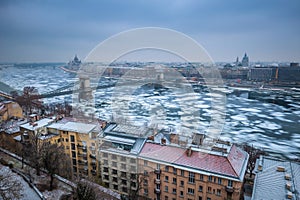 Budapest, Hungary - Panoramic skyline view of the Szechenyi Chain Bridge on the icy River Danube with Parliament and Bazilika