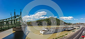 Budapest, Hungary - Panoramic view of Liberty Bridge, Gellert Hill with Statue of Liberty, the Citadel, Royal Palace Buda Castle