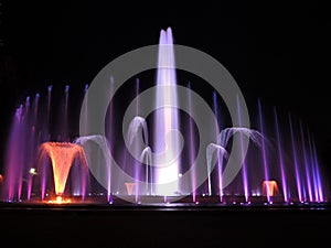 Colorful musical fountain. Magnificent night show of colorful lights, laser beams, music