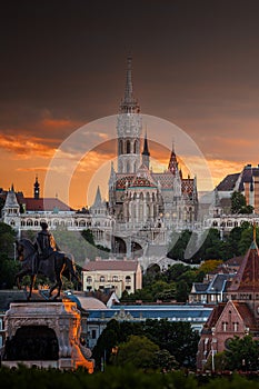 Budapest, Hungary - St Matthias Church and Fisherman`s Bastion Halaszbastya with beautiful golden sunset and dramatic sky on a s