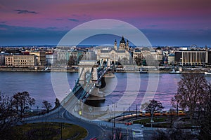 Budapest, Hungary - The Szechenyi Chain Bridge at sunset decorated with national flags celebrating the 15th of March 1848