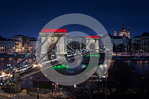 Budapest, Hungary - The world famous illuminated Szechenyi Chain Bridge Lanchid by night, lit up with national tricolors