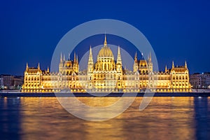 Budapest parliament illuminated at night and Danube river Hungary