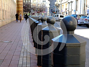 Budapest streetscape in diminishing perspective with bollards and tourists
