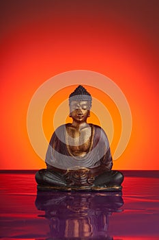 budda with red reflecting background