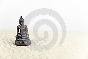 Buddha and abstract Zen drawing on white sand. Concept of harmony, balance and meditation, spa, massage, relax.