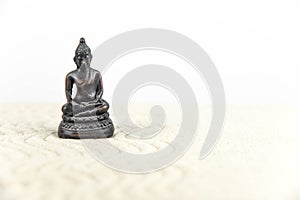 Buddha and abstract Zen drawing on white sand. Concept of harmony, balance and meditation, spa, massage, relax.