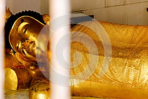 Buddha amulet reclining posture, the Buddha image is in the right side of the Ariya Buddha image. His Majesty`s feet overlap