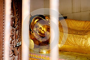 Buddha amulet reclining posture, the Buddha image is in the right side of the Ariya Buddha image. His Majesty`s feet overlap