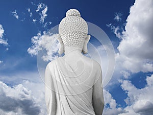 Buddha as seen from behind with cloudscape