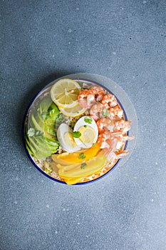 Buddha bowl with avocado, prawns, rice, on light background. Healthy food, clean eating, Buddha bowl, top view