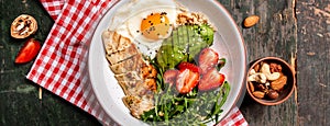 Buddha bowl with chicken, arugula and strawberries. keto diet food recipe background. Long banner format, top view